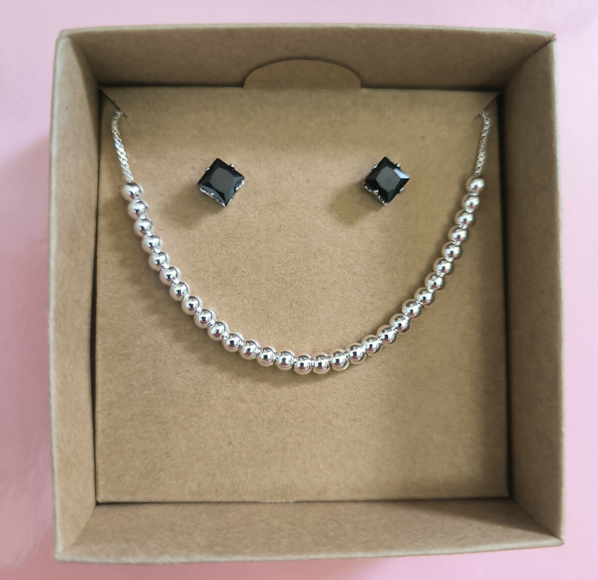 Set Aretes y Pulsera América en Acero Plateado